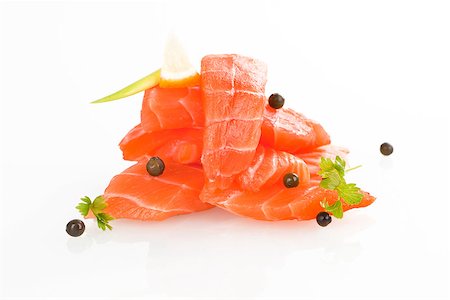 simsearch:400-08187570,k - Sashimi sushi. Raw salmon pieces arranged on white background. Stockbilder - Microstock & Abonnement, Bildnummer: 400-07667164