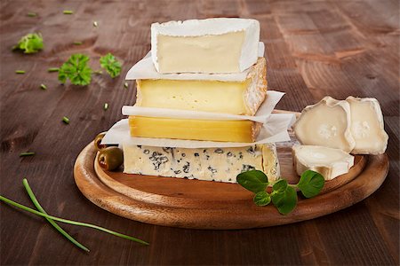 emmentaler cheese - Luxurious cheese variation on wooden board with parsley and chive. Stock Photo - Budget Royalty-Free & Subscription, Code: 400-07667172