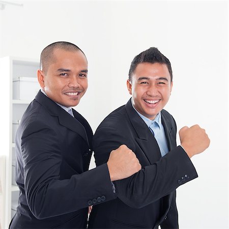 Southeast Asian business men celebrating success in office. Stock Photo - Budget Royalty-Free & Subscription, Code: 400-07667593