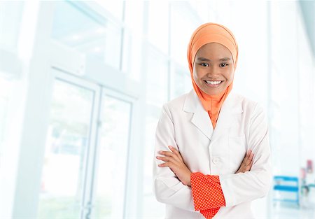 Cheerful young Muslim female nurse portrait, standing inside hospital Stock Photo - Budget Royalty-Free & Subscription, Code: 400-07667634