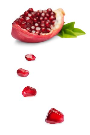 simsearch:400-06457388,k - Juicy slice pomegranate fruit  isolated on a white background Photographie de stock - Aubaine LD & Abonnement, Code: 400-07667694