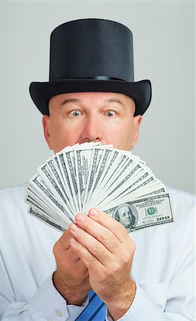 simsearch:400-05746567,k - Surprised and amazed middle aged man in a retro top hat with money.Focus on the cash. Stock Photo - Budget Royalty-Free & Subscription, Code: 400-07667706