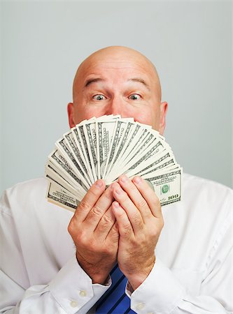 simsearch:400-05746567,k - Surprised and amazed middle aged man with money.Focus on the cash. Stock Photo - Budget Royalty-Free & Subscription, Code: 400-07667707