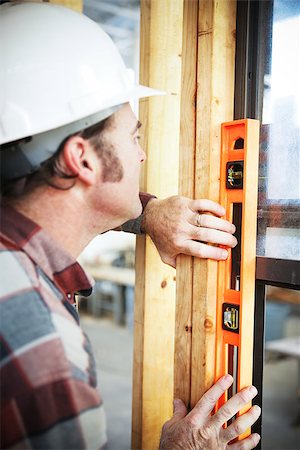 simsearch:400-07304331,k - Construction carpenter using level to check his work. Stock Photo - Budget Royalty-Free & Subscription, Code: 400-07669017