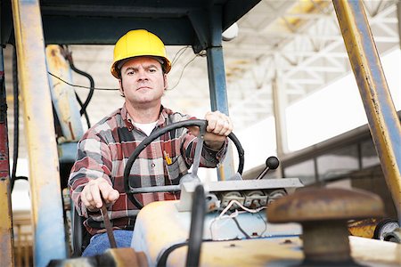 forklift operating gear picture - Worker driving heavy construction equipment - bulldozer or backhoe. Stock Photo - Budget Royalty-Free & Subscription, Code: 400-07669022