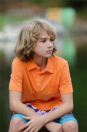 Young boy focused on something next to him Fotografie stock - Microstock e Abbonamento, Codice: 400-07669083