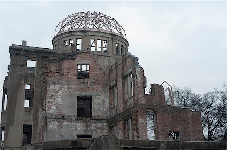 View of the stark ruins of the Hiroshima Atom Bomb Dome, one of the few buildings left standing after the bombing of Hiroshima, now part of the Peace Memorial known as the Genbaku Dome or A-Bomb Dome Stock Photo - Budget Royalty-Free & Subscription, Code: 400-07660084