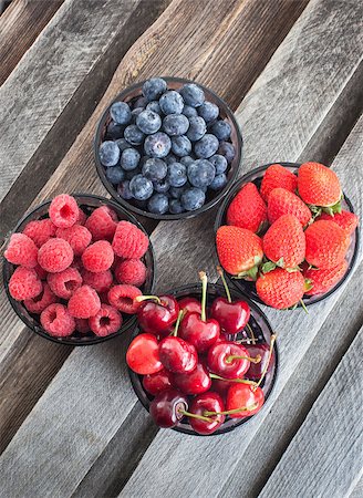 simsearch:400-08672192,k - Fresh cherry, strawberry, blueberry and raspberry in a bowls on wooden table Photographie de stock - Aubaine LD & Abonnement, Code: 400-07660392