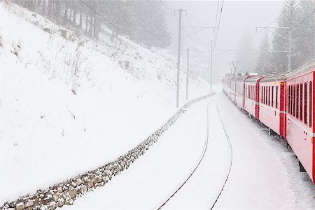 The famous Bernina red train, Unesco monument, in the middle of a winter storm Stock Photo - Budget Royalty-Free & Subscription, Code: 400-07662323