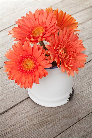 simsearch:400-07179442,k - Orange gerbera flowers in pitcher on wooden table Stock Photo - Budget Royalty-Free & Subscription, Code: 400-07662640