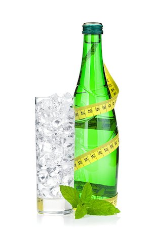 Glass of water with ice, bottle, measuring tape and mint. Isolated on white background Stock Photo - Budget Royalty-Free & Subscription, Code: 400-07662746