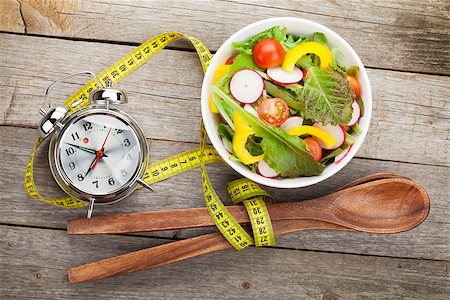 simsearch:400-06485512,k - Fresh healthy salad and measuring tape on wooden table. Healthy food Stock Photo - Budget Royalty-Free & Subscription, Code: 400-07662750