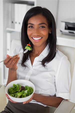 Casual pretty businesswoman eating a salad at her desk in her office Stock Photo - Budget Royalty-Free & Subscription, Code: 400-07662832