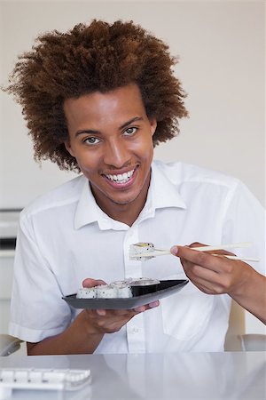 simsearch:689-03124356,k - Casual smiling businessman eating sushi at his desk in his office Stock Photo - Budget Royalty-Free & Subscription, Code: 400-07662888