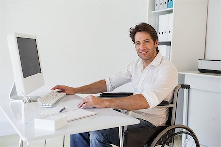 disability office - Casual businessman in wheelchair working at his desk in his office Stock Photo - Budget Royalty-Free & Subscription, Code: 400-07662882
