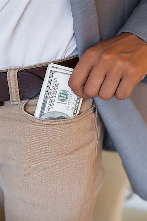 pictures of man lying on money - Dodgy businessman pocketing wad of dollars in his office Stock Photo - Budget Royalty-Free & Subscription, Code: 400-07662925