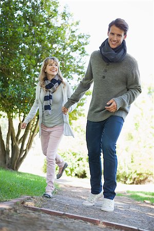 Cute couple walking hand in hand in the park on a sunny day Stock Photo - Budget Royalty-Free & Subscription, Code: 400-07663623