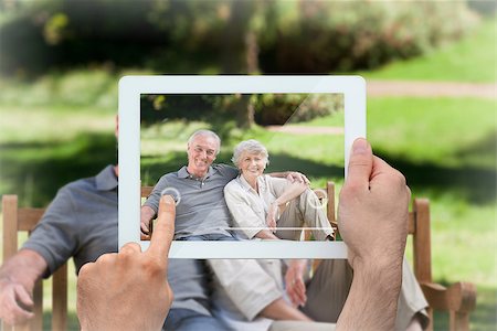 simsearch:400-07664794,k - Hand holding tablet pc showing senior couple sitting on a bench Stock Photo - Budget Royalty-Free & Subscription, Code: 400-07663993