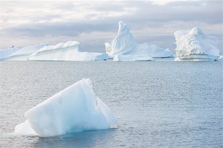 Beautiful icebergs in the sun and in front of a dark sky Stock Photo - Budget Royalty-Free & Subscription, Code: 400-07675616