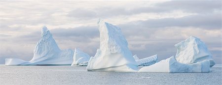 Panorama of beautiful icebergs in the sun and in front of a dark sky Stock Photo - Budget Royalty-Free & Subscription, Code: 400-07675617