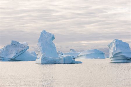 Beautiful icebergs in the sun and in front of a dark sky Stock Photo - Budget Royalty-Free & Subscription, Code: 400-07675618