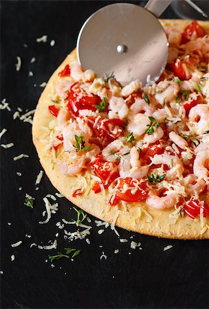 red pepper and basil - Hot shrimp pizza and pizza knife on a black slate board. Stock Photo - Budget Royalty-Free & Subscription, Code: 400-07675992