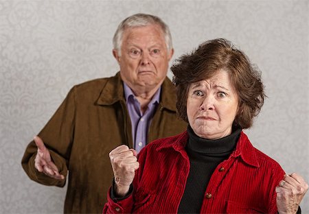 Offended mature wife near frustrated husband with hands up Stock Photo - Budget Royalty-Free & Subscription, Code: 400-07676162