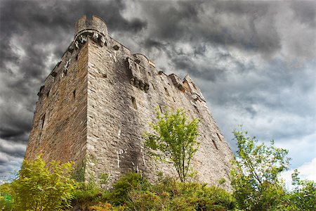 picture of house with high grass - Stormy sky over ruins of a small castle Stock Photo - Budget Royalty-Free & Subscription, Code: 400-07676318