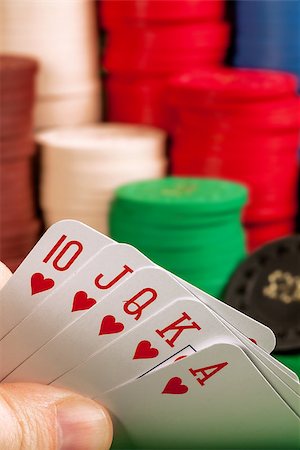simsearch:400-07573978,k - Photo of a person holding a royal flush in front of stacks of gambling chips. Photographie de stock - Aubaine LD & Abonnement, Code: 400-07676491