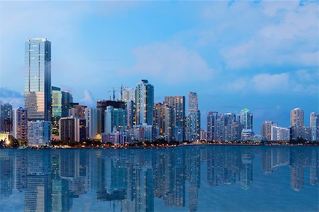 ddmitr (artist) - A shot of beautiful Downtown Miami skyline after sunset with reflection in the water. All logos and advertising removed. Stock Photo - Budget Royalty-Free & Subscription, Code: 400-07676666