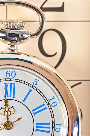 simsearch:400-04736251,k - part of a pocket watch lying on the calendar Stock Photo - Budget Royalty-Free & Subscription, Code: 400-07676792