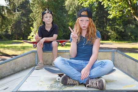 Cool young boy and girl outdoor with skateboard Stock Photo - Budget Royalty-Free & Subscription, Code: 400-07678537