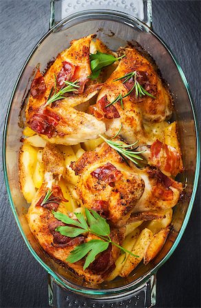 Tasty baked chicken with potatoes and herbs Stock Photo - Budget Royalty-Free & Subscription, Code: 400-07678572