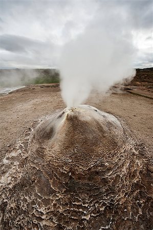 simsearch:632-06030061,k - Fumarole in the geothermal area Hveravellir, central Iceland. The area around is layered and cracked. Photographie de stock - Aubaine LD & Abonnement, Code: 400-07678700