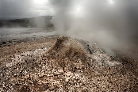 simsearch:632-06030061,k - Fumarole in the geothermal area Hveravellir, central Iceland. The area around is layered and cracked. Photographie de stock - Aubaine LD & Abonnement, Code: 400-07678701
