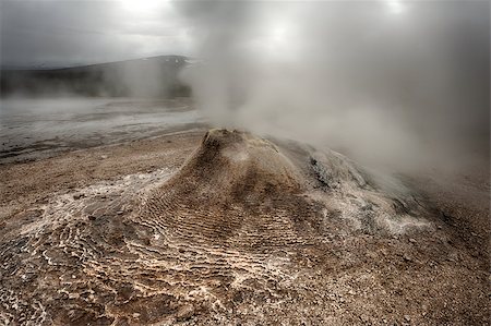 simsearch:400-04839330,k - Fumarole in the geothermal area Hveravellir, central Iceland. The area around is layered and cracked. Photographie de stock - Aubaine LD & Abonnement, Code: 400-07678701