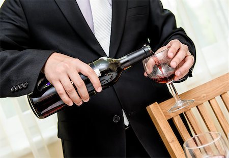 simsearch:400-05286682,k - Man pouring red wine from bottle into a glass Stock Photo - Budget Royalty-Free & Subscription, Code: 400-07679149