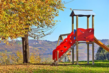 empty playground - Lone children's slide on empty playground in autumn in small town of Diano D'Alba, Italy. Stock Photo - Budget Royalty-Free & Subscription, Code: 400-07679254