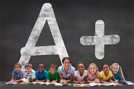 simsearch:400-07684082,k - Cute pupils smiling at camera with teacher against black wall with a plus grade Stock Photo - Budget Royalty-Free & Subscription, Code: 400-07684017