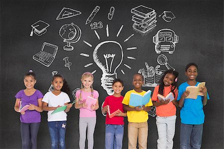 simsearch:400-07684098,k - Elementary pupils reading books against black wall with school doodles Stock Photo - Budget Royalty-Free & Subscription, Code: 400-07684010