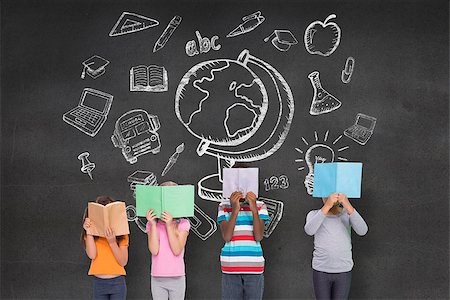 simsearch:400-07684098,k - Elementary pupils reading against black wall with school doodles Stock Photo - Budget Royalty-Free & Subscription, Code: 400-07684012