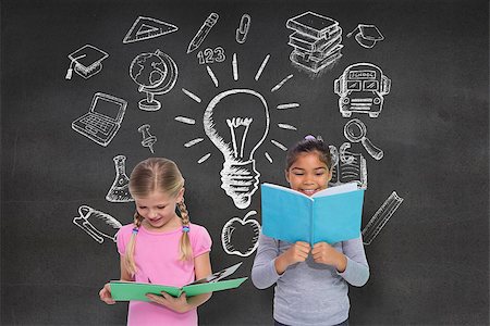 simsearch:400-07684098,k - Elementary pupils reading against black wall with school doodles Stock Photo - Budget Royalty-Free & Subscription, Code: 400-07684013