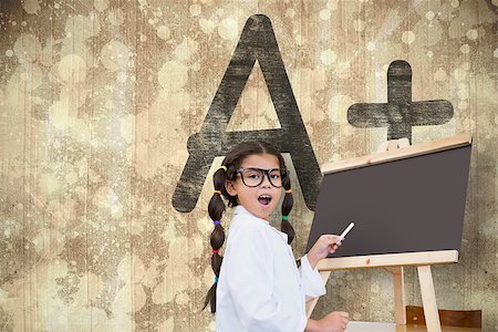 simsearch:400-06876753,k - Cute pupil with chalkboard against wooden surface with planks Photographie de stock - Aubaine LD & Abonnement, Code: 400-07684115