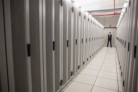 Serious technician standing in server hallway in large data center Stock Photo - Budget Royalty-Free & Subscription, Code: 400-07684429