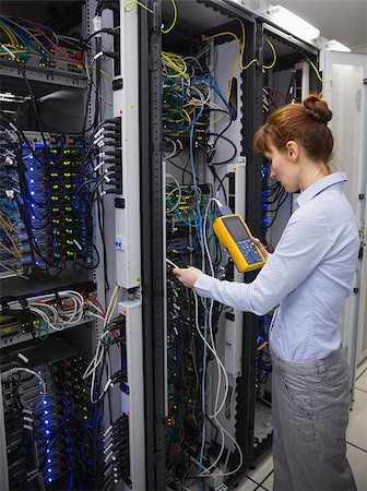 Technician using digital cable analyzer on server in large data center Stock Photo - Budget Royalty-Free & Subscription, Code: 400-07684477