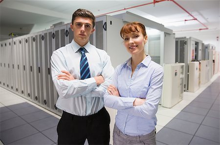 data center male female - Confident data technicians looking at camera  in large data center Stock Photo - Budget Royalty-Free & Subscription, Code: 400-07684532