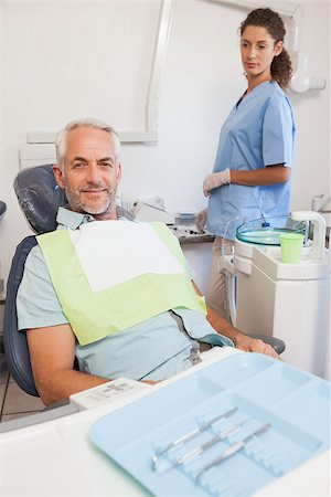 dental work - Patient smiling at camera sitting in the chair at the dental clinic Stock Photo - Budget Royalty-Free & Subscription, Code: 400-07684633