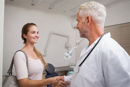 pictures of two nurses shaking hands - Dentist shaking hands with his patient at the dental clinic Stock Photo - Budget Royalty-Free & Subscription, Code: 400-07684777