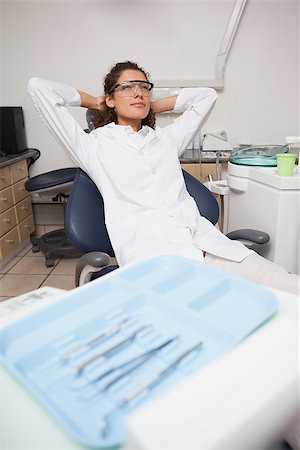 dentist tray - Dentist sitting back and relaxing at the dental clinic Stock Photo - Budget Royalty-Free & Subscription, Code: 400-07684819