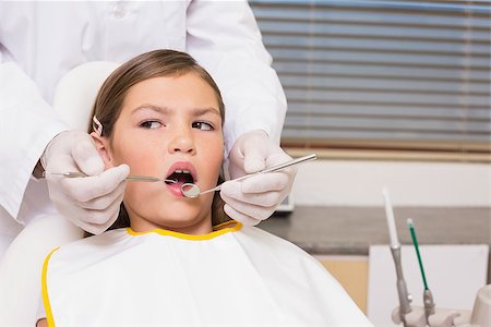 simsearch:400-07684901,k - Pediatric dentist examining a patients teeth in the dentists chair at the dental clinic Stock Photo - Budget Royalty-Free & Subscription, Code: 400-07684865